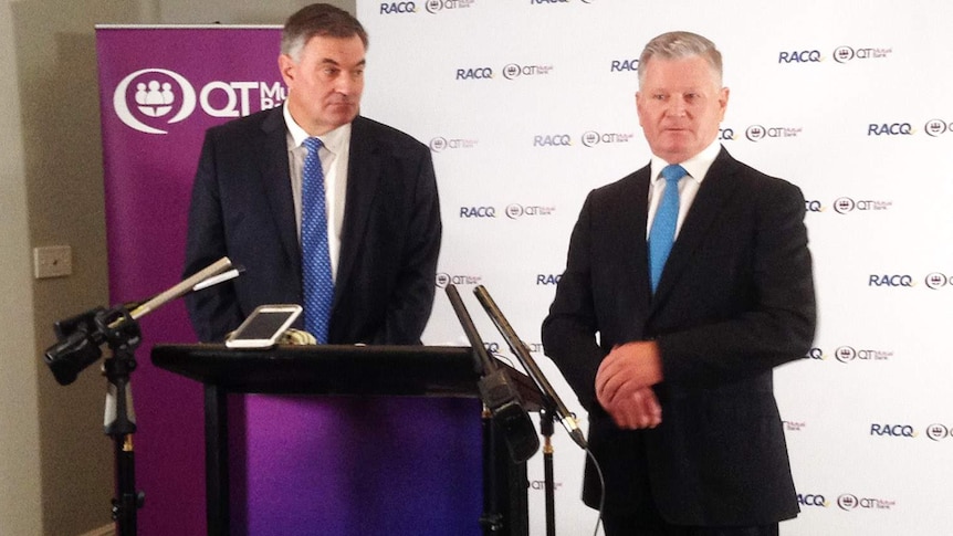 The RACQ's Ian Gillespie and QT Mutual Bank's Steve Targett at a podium to launch merger plans