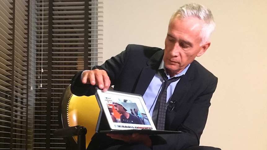Jorge Ramos holds up a tablet with what he claims is a video of Venezuelans eating food scraps from a garbage truck.