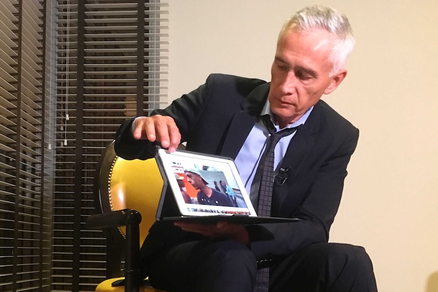 Jorge Ramos holds up a tablet with what he claims is a video of Venezuelans eating food scraps from a garbage truck.