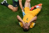 A trainer checks on Australia's Ivan Franjic against Chile in Cuiaba at the 2014 World Cup.