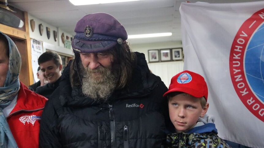 Fedor Konyukhov looks down as his son looks away from the camera