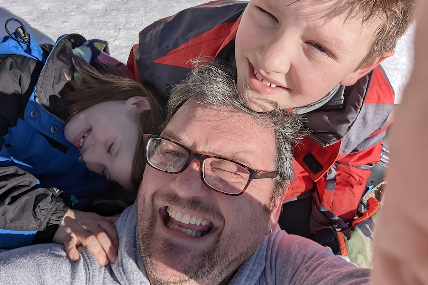 joe belfrage with his two children at the snow