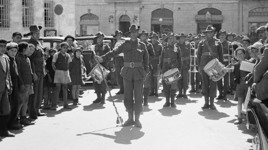 An Australian military band leading a parade of soldiers in Jerusalem in 1940.