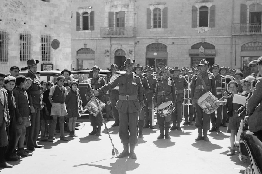An Australian military band leading a parade of soldiers in Jerusalem in 1940.