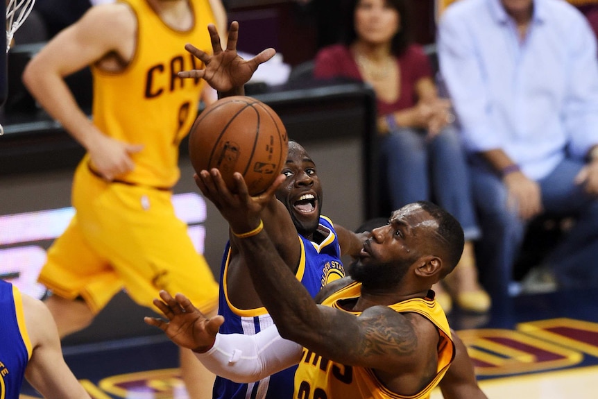 Cleveland Cavaliers' LeBron James goes up against Golden State's Festus Ezeli in the NBA Finals.