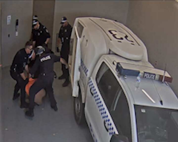 Closed circuit television image of a police officer allegedly punching Carl Hoppner in custody.