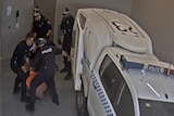 Closed circuit television image of a police officer allegedly punching Carl Hoppner in custody.
