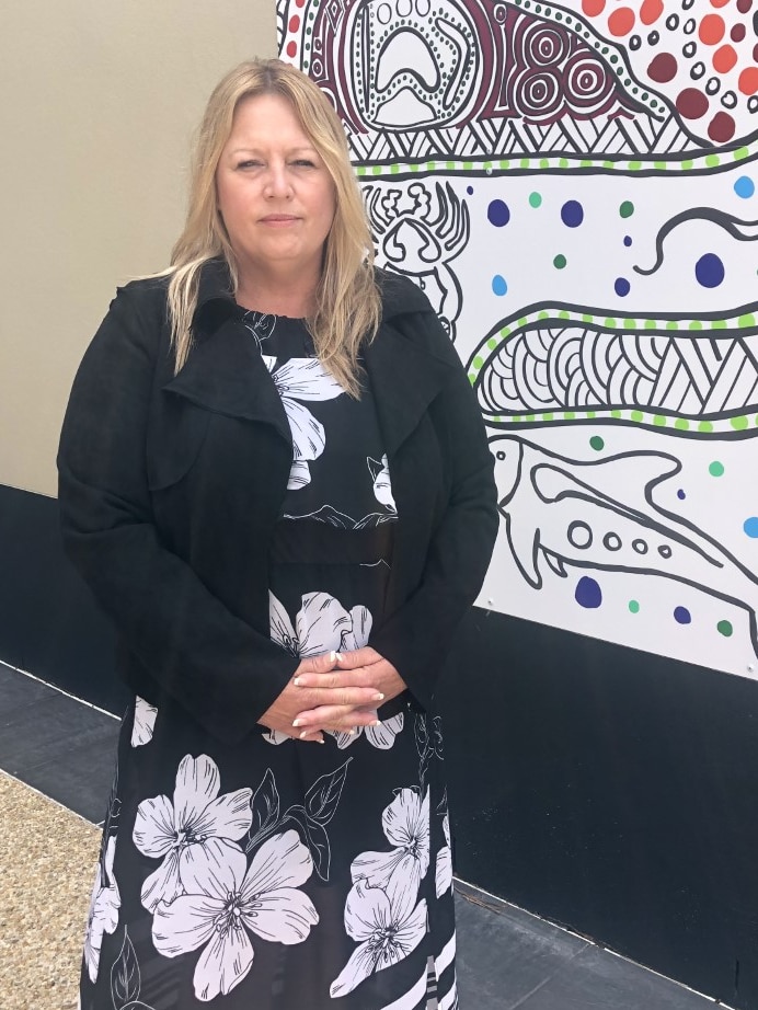 The Mayor of Port Macquarie Hastings Council Peta Pinson standing in front of indigenous painting
