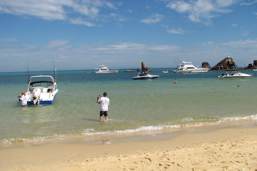 Boats in the water near the wrecks off Moreton Island and Tangalooma Resort.