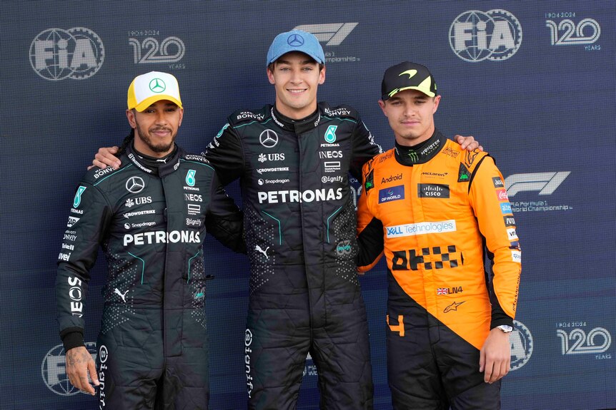 George Russell, Lewis Hamilton and Lando Norris stand together