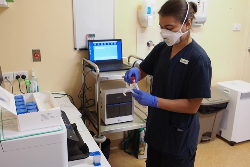 A doctor at Broome hospital with the GeneXpert machine
