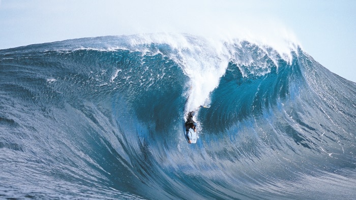 A bodyboarder rides a big wave