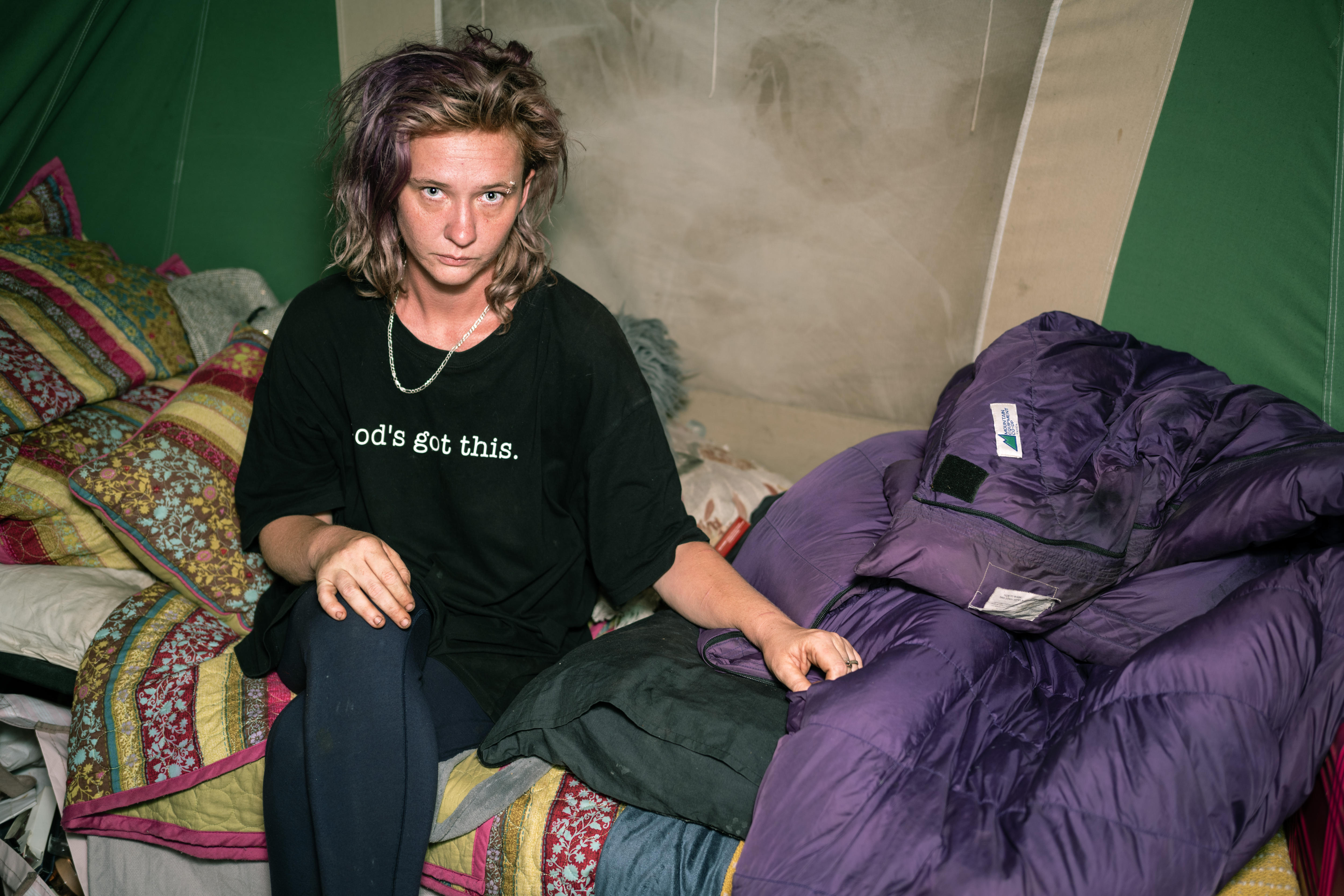 A woman in a grubby tent