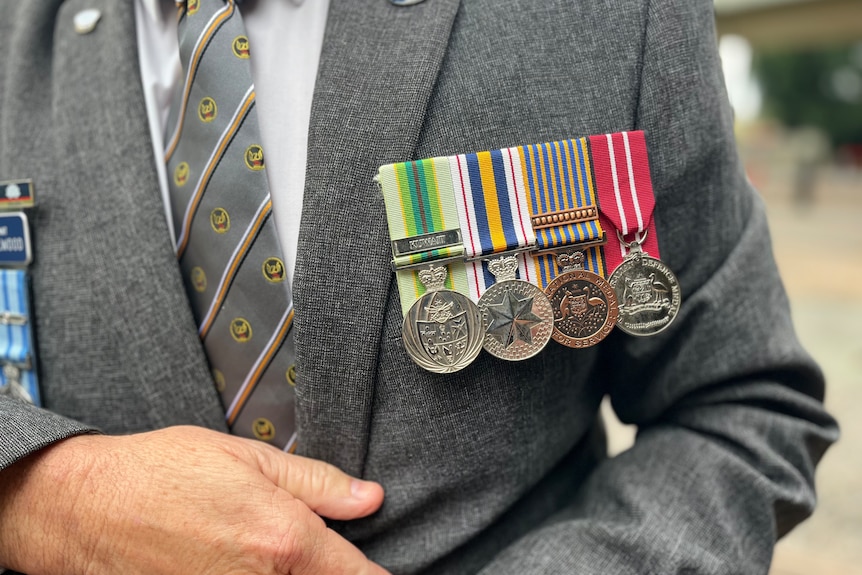 Close up of war medals on a suit jacket.