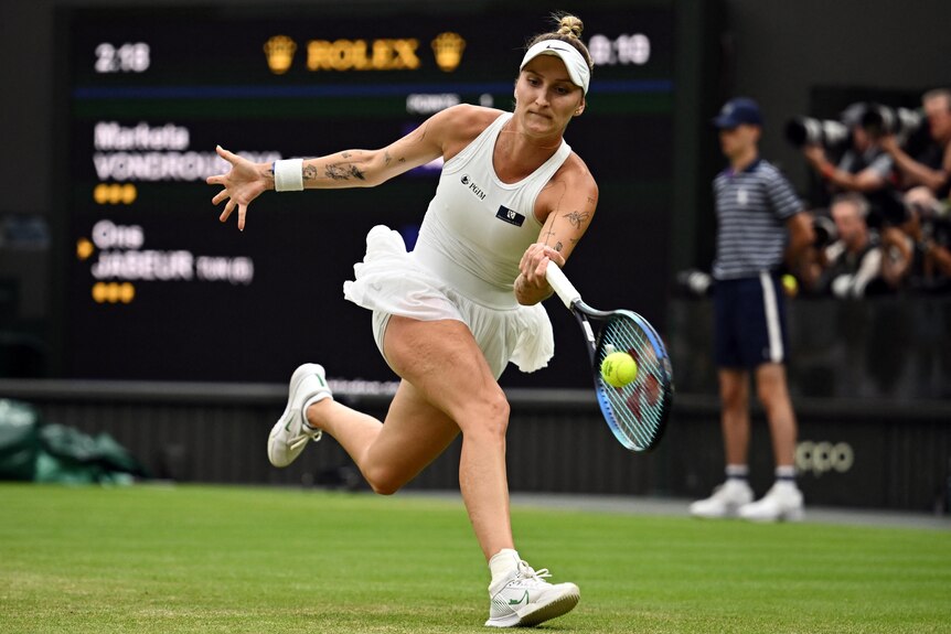Action shot of Marketa Vondrousova running and hitting a tennis ball