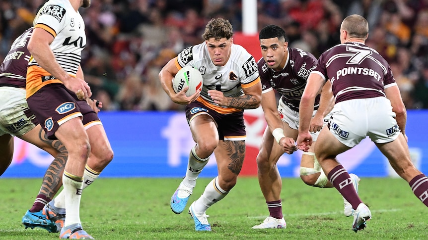 Brisbane Broncos' Reece Walsh makes a run in an NRL game against Manly Sea Eagles.