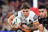 Brisbane Broncos' Reece Walsh makes a run in an NRL game against Manly Sea Eagles.