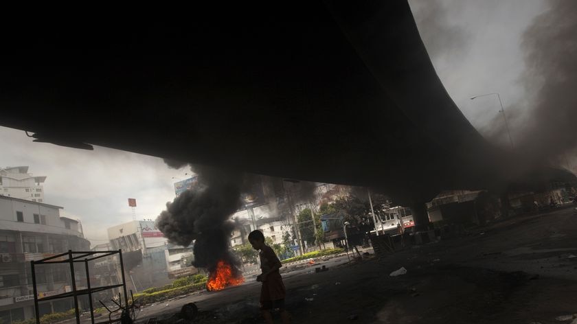 A boy walks under an overpass in Ding Daeng, near Bangkok's Victory Monument