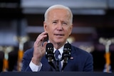 Joe Biden gestures as he speaks at a lectern