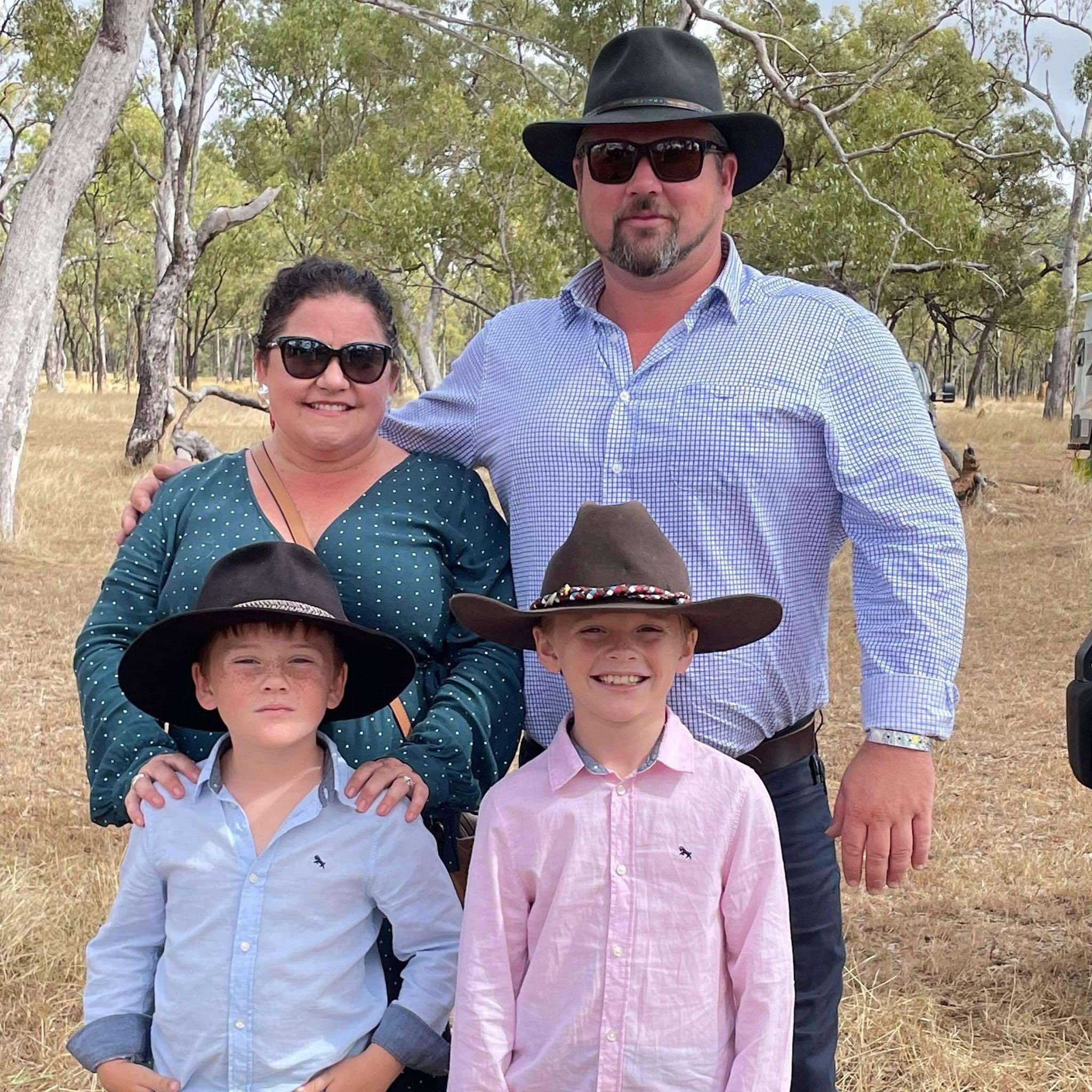 A picture of a family - four people one female two male children and a man