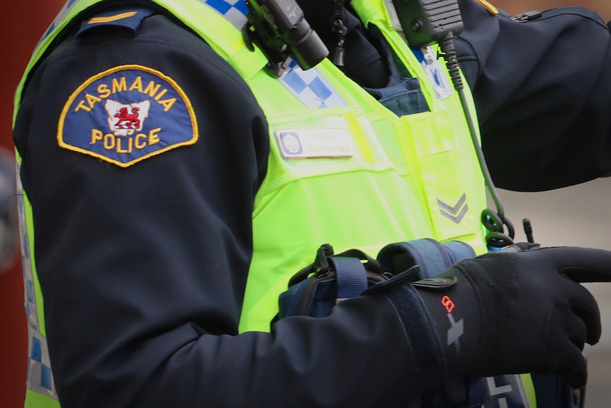Tasmania Police officer wearing high-vis vest.