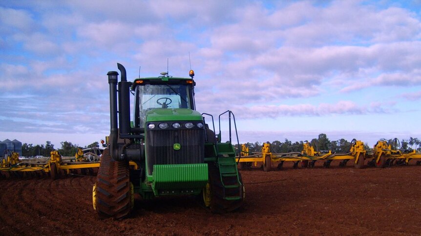 A tractor works a paddock