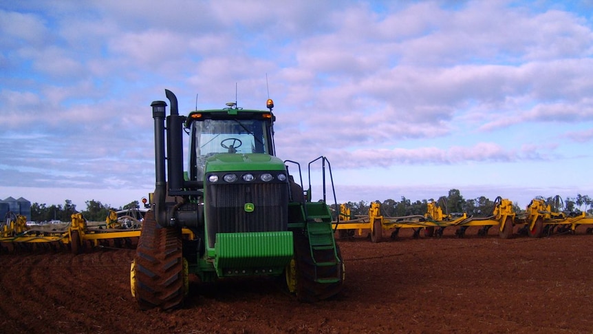 A tractor works a paddock