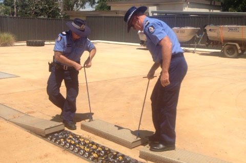 Kimberley police test a new device designed to destroy black market liquor in Fitzroy Crossing on March 10, 2014.