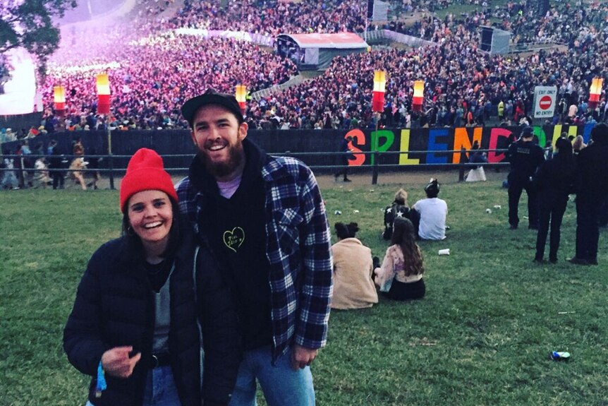 A young couple smile at the Splendour in the Grass festival.