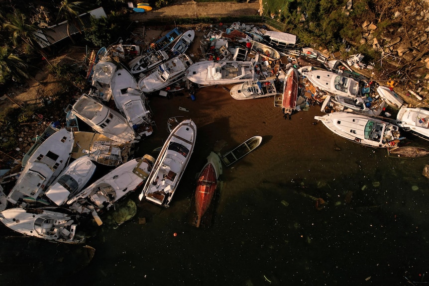 An aerial image looking down piles of smashed fishing boats. 
