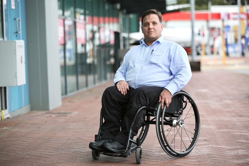 Stuart Jenkinson in his wheelchair outside his office.