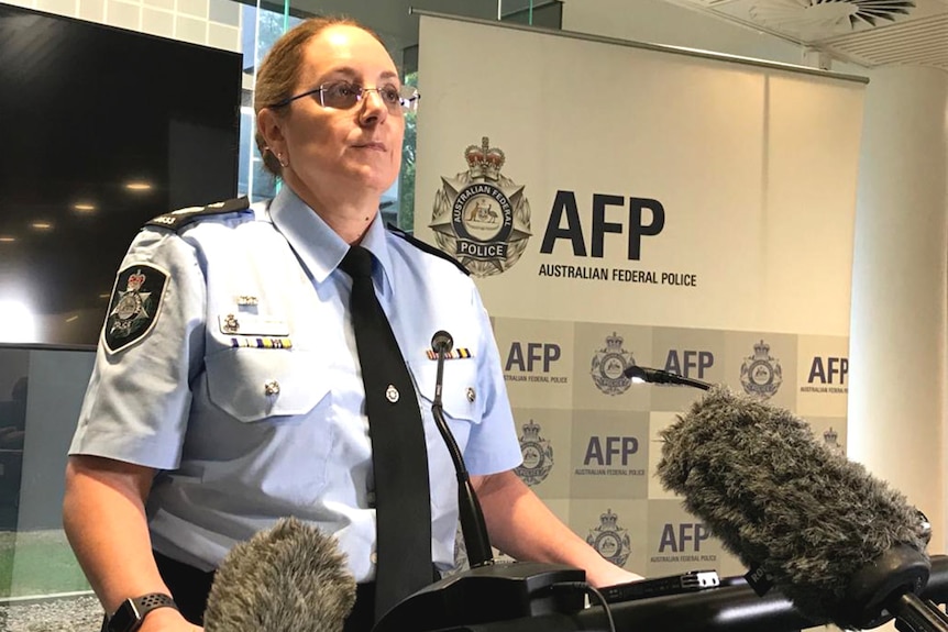 A senior Australian Federal Police officer speaks to the media