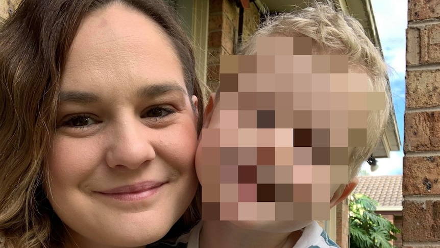 Photo of a young woman with her child, child's face pixelated