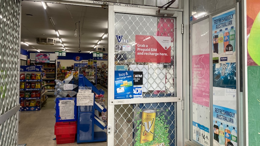 A convenience store with a security door