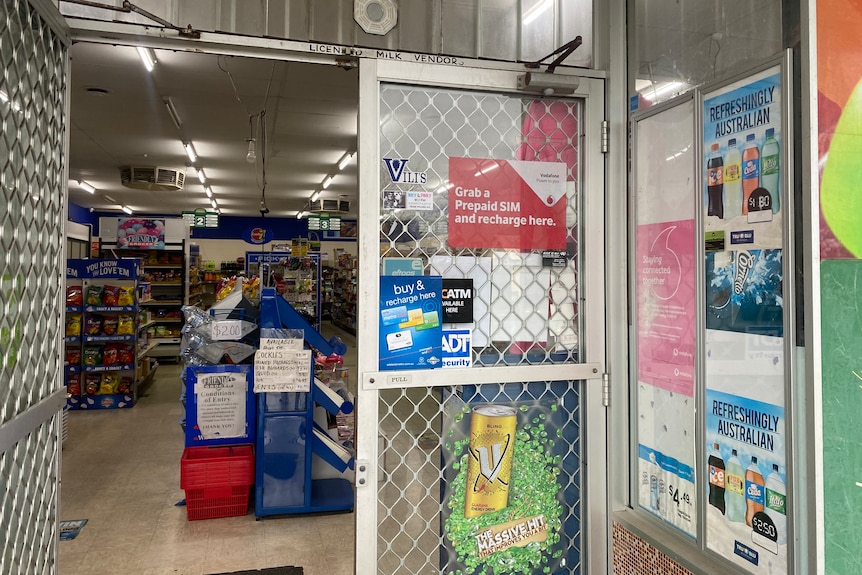 A convenience store with a security door