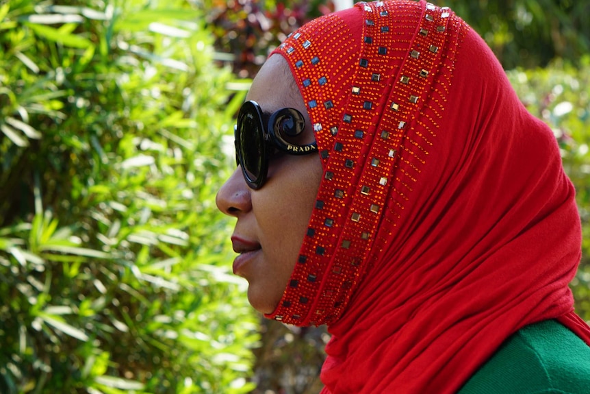 Fatima Hamza, whose husband died smuggling heroin, wears Prada sunglasses and a red headscarf.