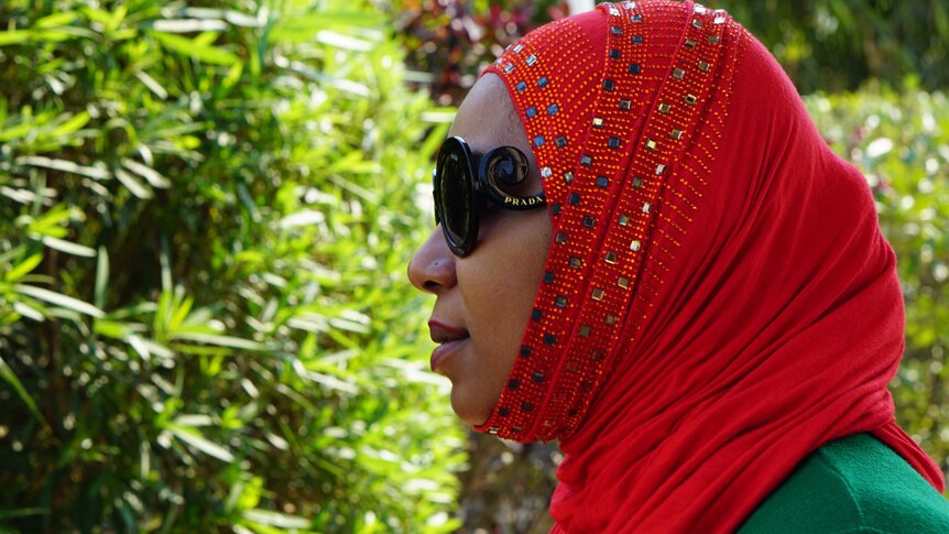Fatima Hamza, whose husband died smuggling heroin, wears Prada sunglasses and a red headscarf.