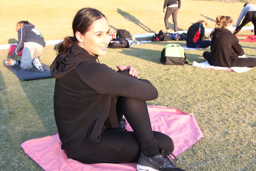 Erin Guy stretching at Sydney Olympic Park in Homebush