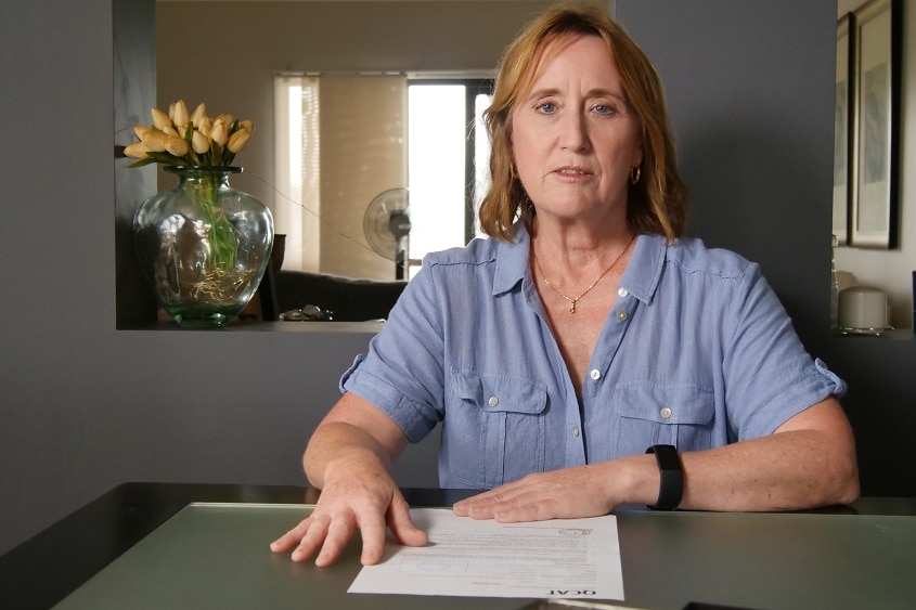 A woman sitting at a table with paper in front of her. Ausnew Home Care, NDIS registered provider, My Aged Care