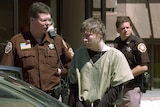 Brendan Dassey is lead out of the Manitowoc County Courthouse in May 2006.