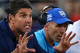 Bulldogs coach Trent Barrett holds out his hands during a game against the Roosters