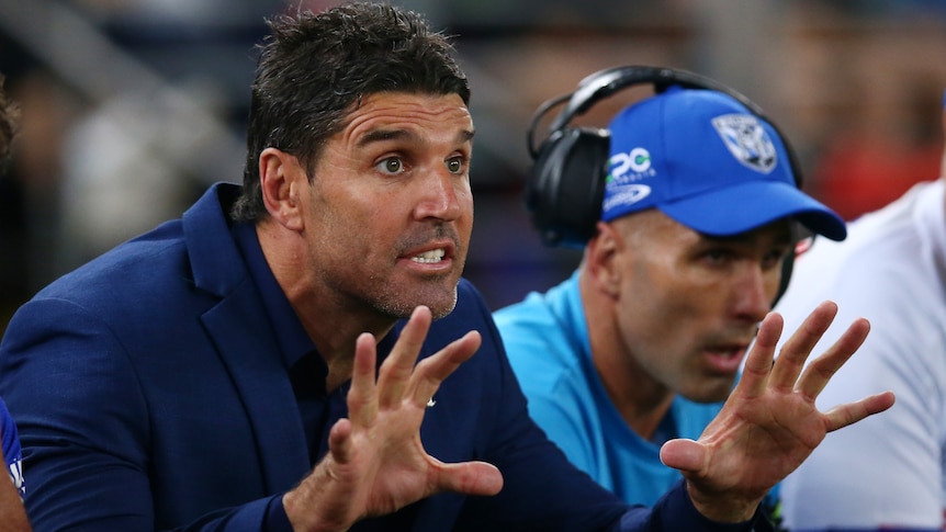 Bulldogs coach Trent Barrett holds out his hands during a game against the Roosters