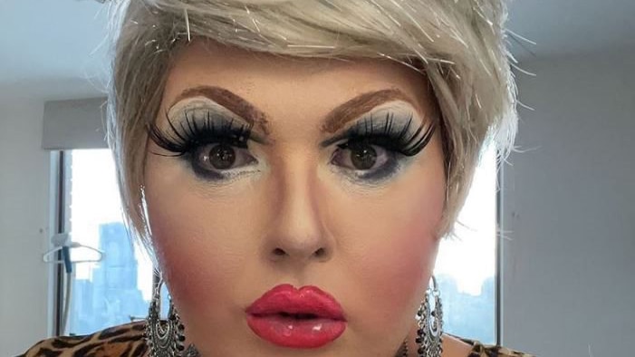 Headshot of a drag queen in heavy makeup.