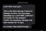 A screenshot of a text message advising someone they are a low risk close contact and to monitor and test if symptomatic