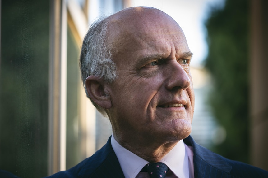 A head shot of a middle aged man in a suit 