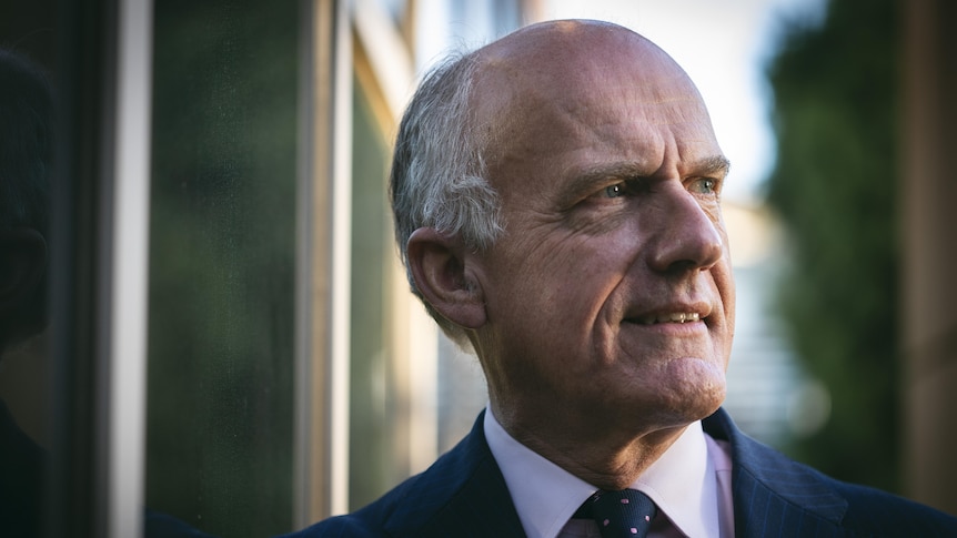 A head shot of a middle aged man in a suit 