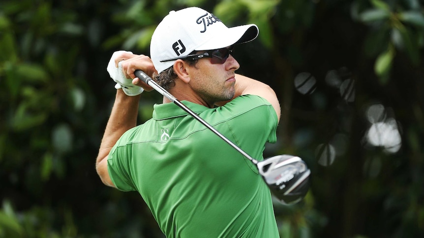 Front runner ... Adam Scott plays a tee shot during day three