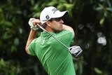 Front runner ... Adam Scott plays a tee shot during day three