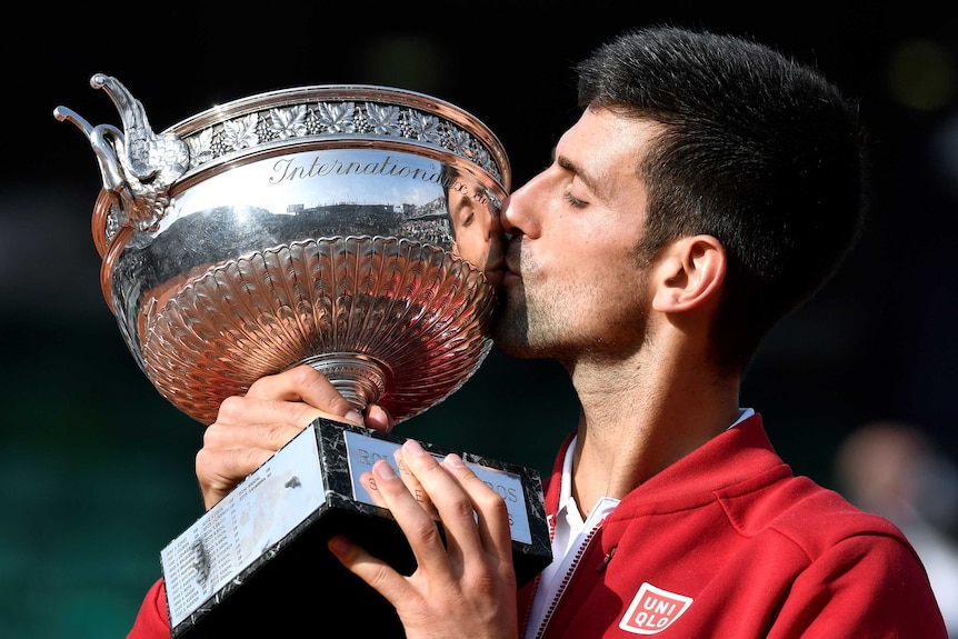 Novak Djokovic kisses the French Open trophy