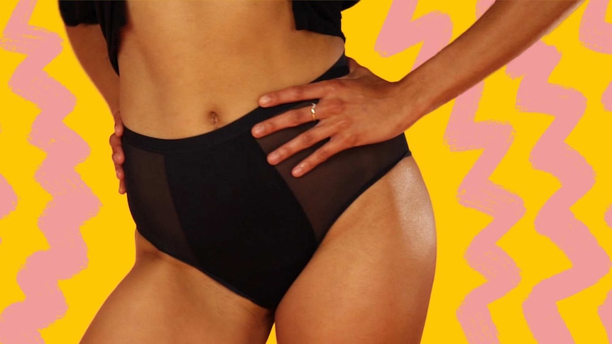 Woman wearing black period underwear with hand on hip, yellow and pink colours in background, to depict how period panties work.